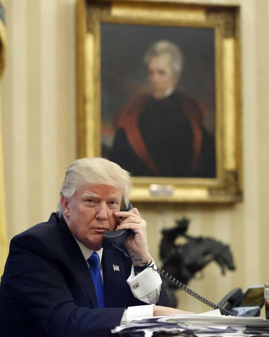Donald Trump sits in the Oval Office beneath the portrait of President Andrew Jackson, a populist seen by some as a model for his presidency.