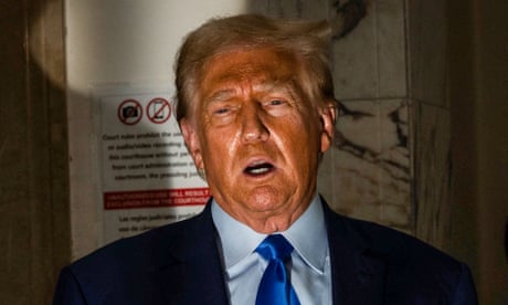 A man in a blue suit and a blue tie speaks