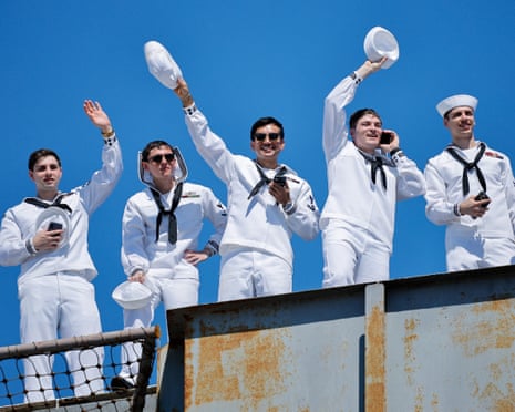 Sailors wave their hats from the USS Abraham Lincoln as it returns home, 8 October 2026.