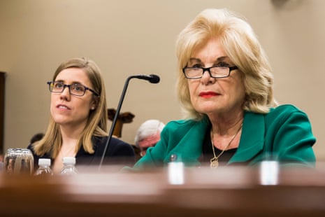 a woman looks out from behind a microphone