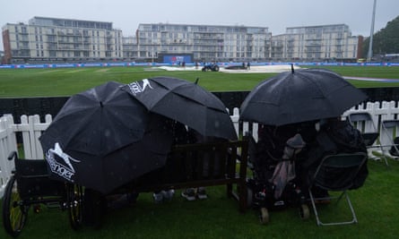 Spectators shelter under umbrellas at the County Ground as rain halts play during England’s ODI against Ireland on 26 September 2023. 