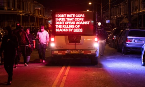 A truck displays a sign as protesters march in West Philadelphia.