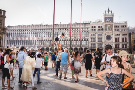 Tourists take over San Marco square during the traditional Festa del Redentore in Venice. The offer of residential apartments for short stays is one of the main drivers of AC adoption in touristic cities. Italy, 2015