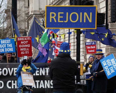 People holding signs reading: 'Brexit got the UK done' 'Brexit: not going well is it!' and 'Brexit lie: take back control'
