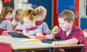 Young schoolchildren using tablet computers in the classroom