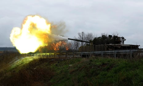 Ukrainian soldiers fire a round from a former Russian tank, in Bakhmut.