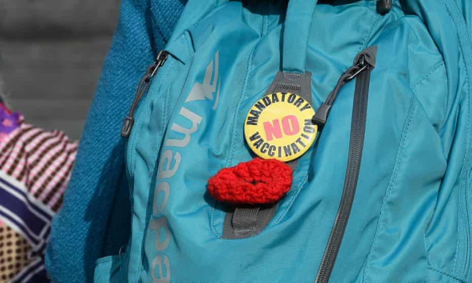 An anti-vaccination badge on a bag