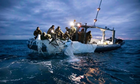 This picture provided by the US Navy shows sailors assigned to Explosive Ordnance Disposal Group 2 recover a high-altitude surveillance balloon off the coast of Myrtle Beach, South Carolina, in the Atlantic ocean on February 5, 2023.