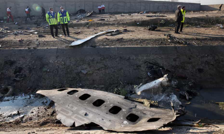 Officials stand near the wreckage of a Ukraine International Airlines Boeing 737-800 after it was shot down in Iran in January 2020. The disaster accounted for more than half of the year’s aviation deaths.