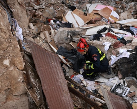 A rescuer in the rubble of the building
