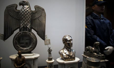A police officer stands next to Nazi artefacts during a news conference at the Holocaust museum in Buenos Aires. Argentina has a sad history as a bolthole for Nazi war criminals.