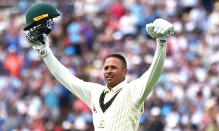 Usman Khawaja raises his arms after reaching his first century of ashes in England.