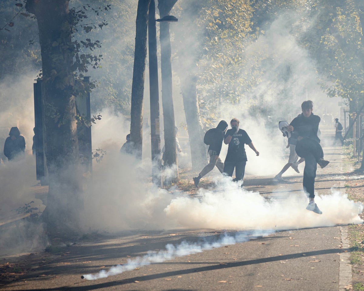 Students kick back tear gas canisters as they carry out a blocking protest at the Strasbourg University, in Strasbourg, eastern France.