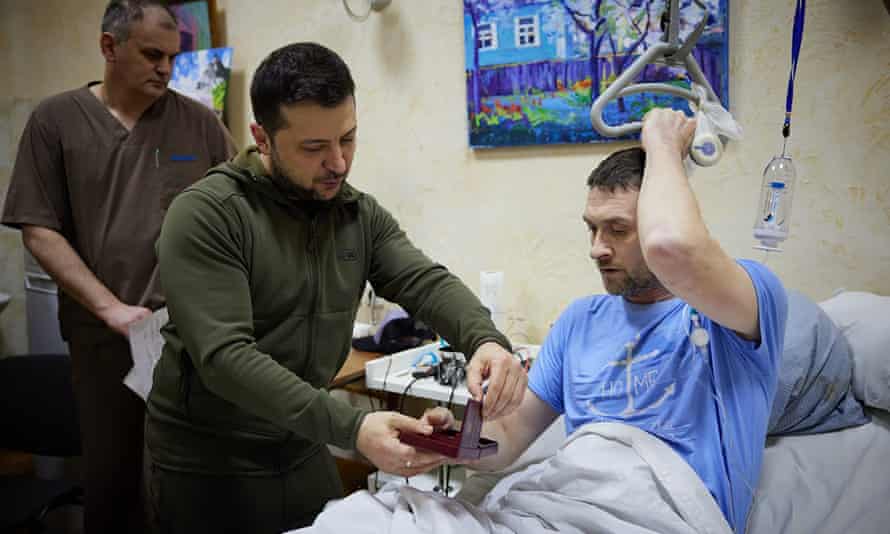 El presidente de Ucrania, Volodymyr Zelensky, entrega una medalla oficial a un soldado herido durante su visita a un hospital en Kiev.