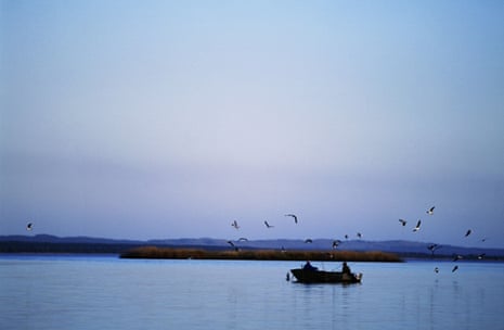 Fishers in a boat surrounded by gulls on Lake St Lucia.