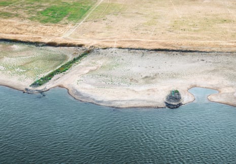 Riverbanks during prolonged dry weather across Europe that has left the Rhine River at near-record low levels, disrupting German industries.