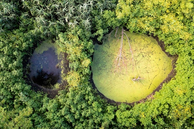 Craters formed by Russian shells dot the floodplains of the Irpin between the villages of Moschun and Rakivka.