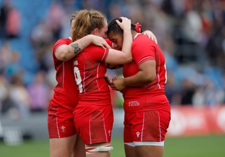 The dejected replacement Wales prop Sisilia Tuipulotu is consoled by teammate Abbie Fleming after the final whistle meant a heavy Welsh defeat.