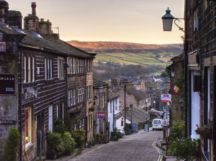 Cobbled street and old houses with moors in the distance