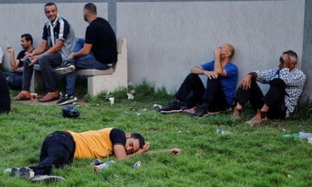 Palestinian workers rest as they wait to cross from Gaza into Israel at Erez