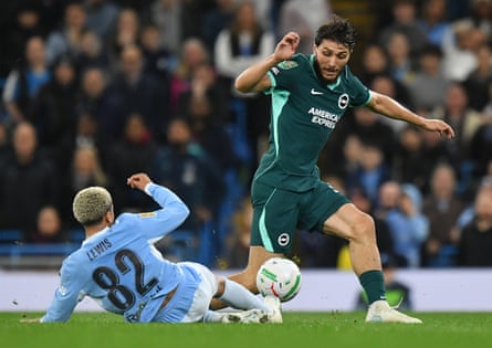 Brighton’s Jaouen Hadjam is tackled by Manchester City’s Rico Lewis during the Carabao Cup match on Wednesday