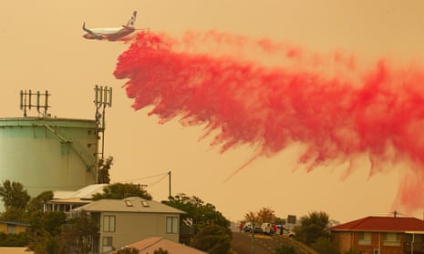 A water bombing plane drops fire retardant on a bushfire
