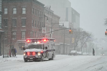 an ambulance on a snow covered street