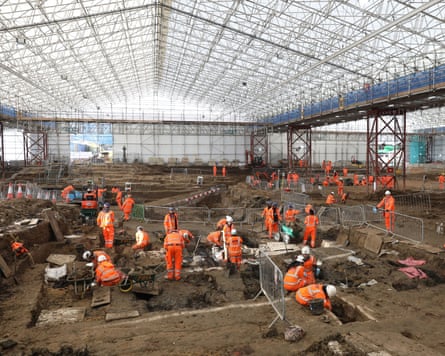 Archaeologists in orange hi-vis uniform working in St James’s burial ground