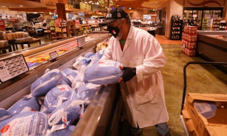 Butcher Raul Garcia places turkeys in the frozen food area at the Schnucks Grocery Store in Des Peres, Missouri.