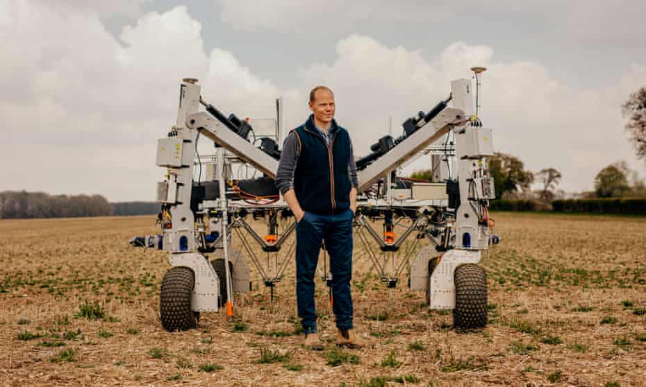 Craig Livingstone in front of the weed-zapping robot Dick