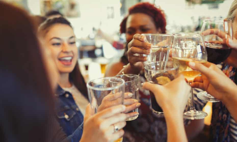Women raising a toast in a pub