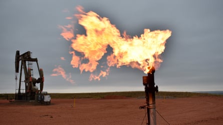 Flames emanating from flaring equipment at a fossil fuel production site.