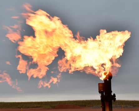 A flare burns at an oil well.