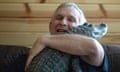 FILE - Joie Henney hugs his emotional support alligator named Wally, Jan. 22, 2019, inside their home in York Haven, Pa. Henney credits Wally for helping relieve his depression for nearly a decade, says he's searching for the reptile after it went missing during a vacation to the coast of Georgia. (Heather Khalifa/The Philadelphia Inquirer via AP, File)