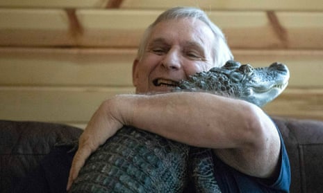 Joie Henney hugs his emotional support alligator named Wally at home in York Haven, Pennsylvania, on 22 January 2019.