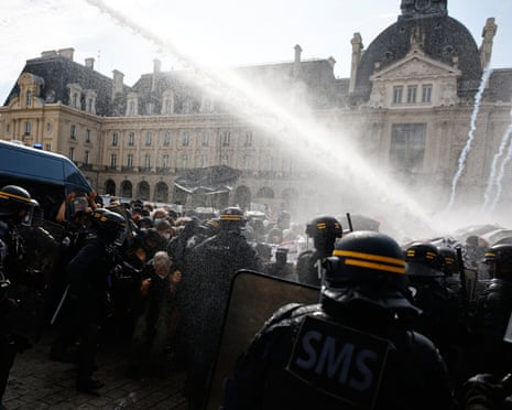 Riot police use water cannon as they face students during a protest in Rennes on Tuesday
