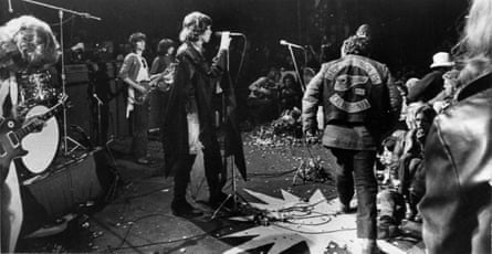 Mick Jagger sings at the Altamont Rock Festival at Livermore, Calif. on Saturday, December 6, 1969 while Hells Angels cross stage during melee to help fellow motorcyclists