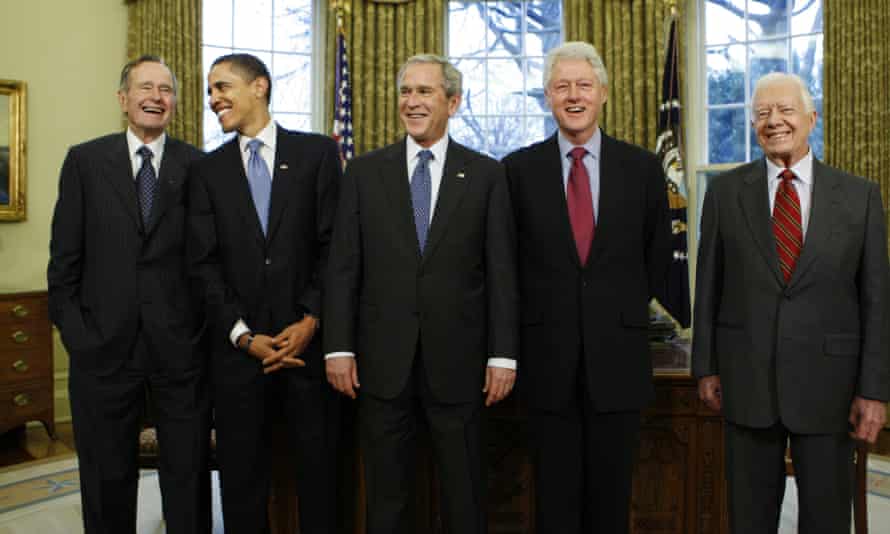 In a picture from January 2009, President-elect Barack Obama is welcomed by President George W Bush, for a meeting at the White House, with George HW Bush, Bill Clinton and Jimmy Carter.