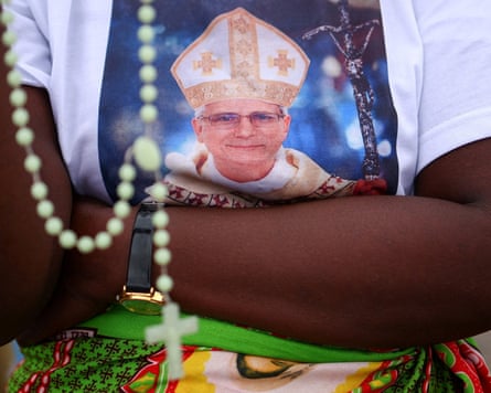 A person wearing a T-shirt with a picture of the pope on it