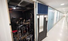 Man playing drums in small storage unit