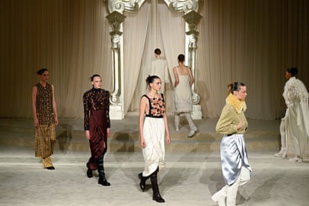 Models wear tops and skirts or trousers, in white, silver, cream, plum and sandy brown and of different textures and fabrics.