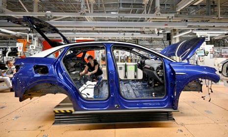 A technician works on an electric car at a Volkswagen plant in Zwickau, Germany.