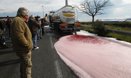 French winemakers empty a Spanish truck’s tanker on April 4, 2016 in Le Boulon, ten kilometers from the French-Spanish border