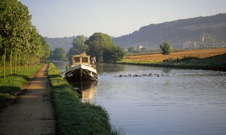 A boat moored up on the tranquil Burgundy Canal, eastern France.