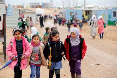 Syrian refugee children walk to school at the Zaatari refugee camp in the Jordanian city of Mafraq, near the border with Syria, December 2016