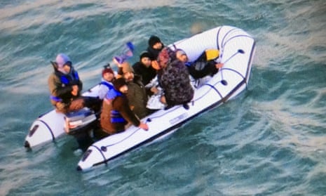 Migrants aboard a rubber boat in the English Channel after being intercepted by French authorities off Calais.