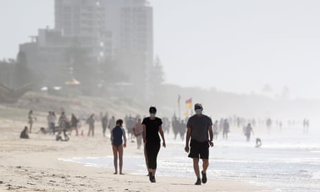 People walk along the beach at Surfers Paradise, Gold Coast, Australia,