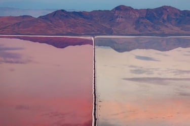 What appears to be a split-screen shot of wetland, one half pink and the other not, with mountains in the background