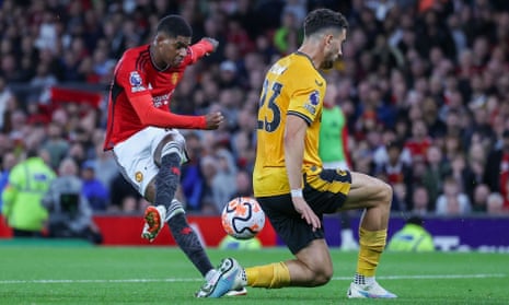 Manchester United Marcus Rashford shot is blocked by Wolves Max Kilman.