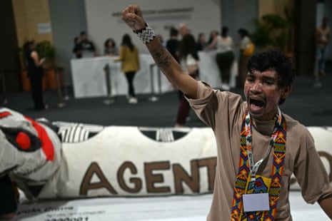 A man shouts slogans demanding climate justice and more protection of indigenous territories at the Blue Zone of Cop30.